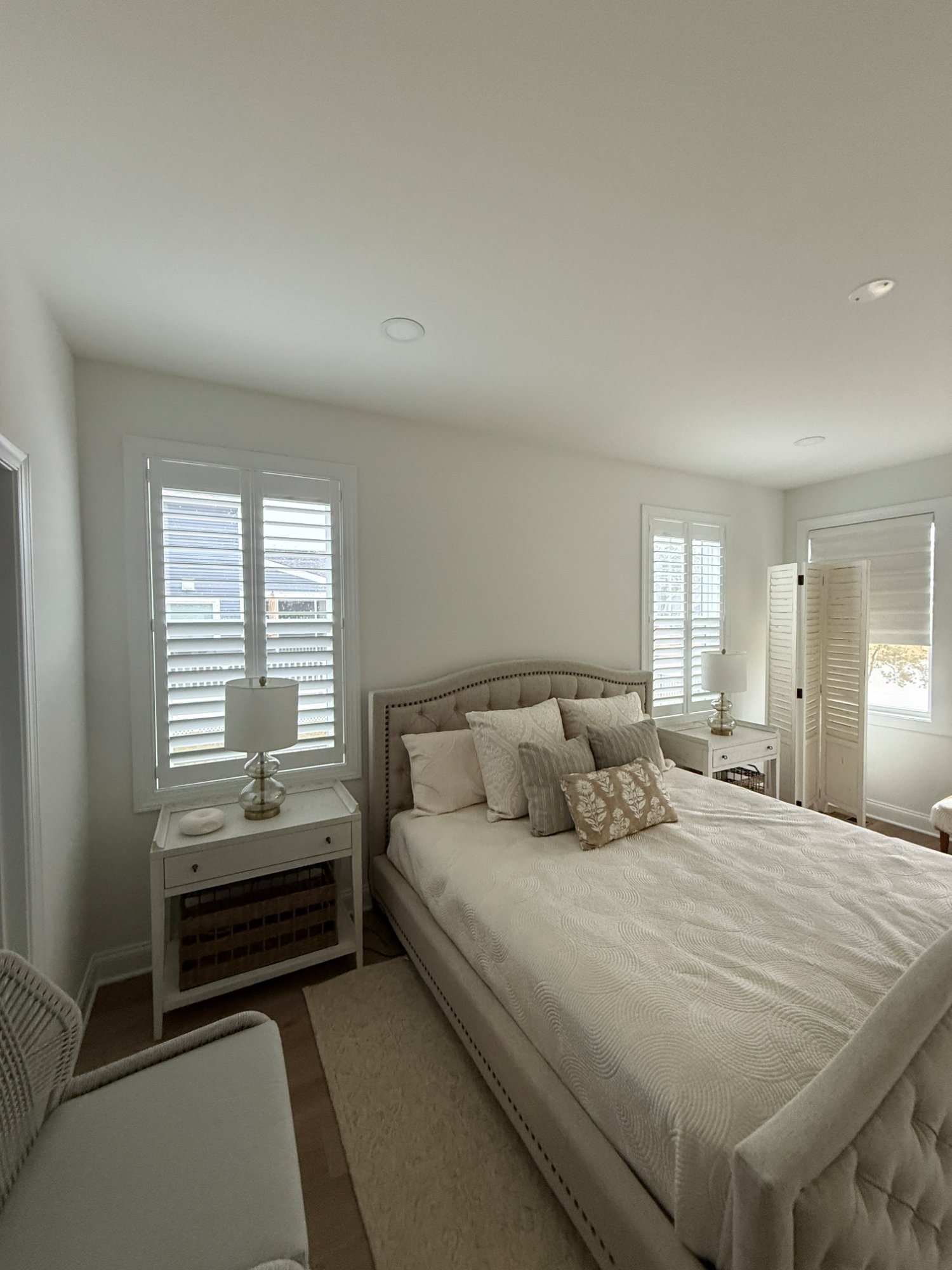 Master bedroom neutral plantation shutters